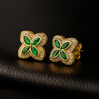 Four Leaf Clover‑shaped earrings covered in small sparkling stones.
