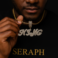 Cursive letter pendant with shimmering stones, hanging from a rope chain.