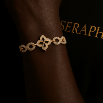 Gold‑tone bracelet featuring alternating infinity links and small four leaf clover shapes studded with stones.