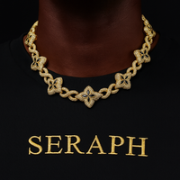 Necklace featuring interlocking infinity symbols and four leaf clover motifs covered in stones.